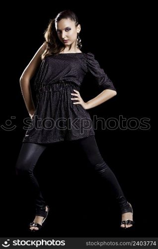 Beautiful fashionable woman posing on black background 