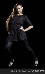 Beautiful fashionable woman posing on black background