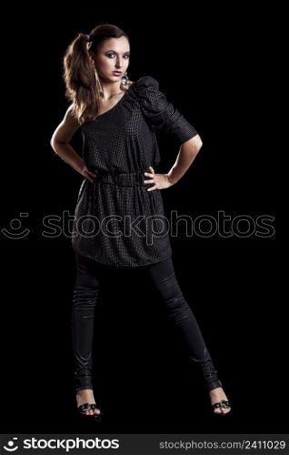 Beautiful fashionable woman posing on black background