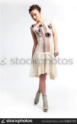 Beautiful fashionable young woman in white dress posing. Beauty. Fashion