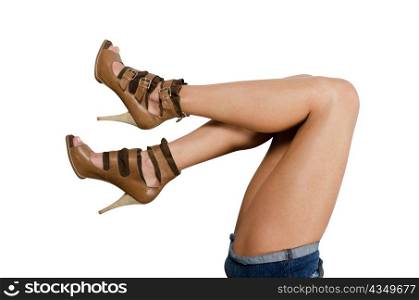 beautiful femail legs in shoes isolated on white