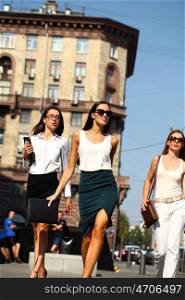 Beautiful Female business team marching down the street in the summer