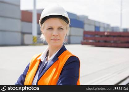 Beautiful female engineer looking away in shipping yard