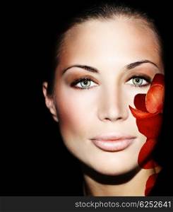 Beautiful female face with flower petals, conceptual image of skincare &amp; youth