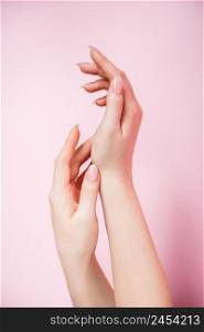 Beautiful female hands on a pink background. Spa and body care concept. Image for advertising.. Beautiful female hands on pink background. Spa and body care concept. Image for advertising.