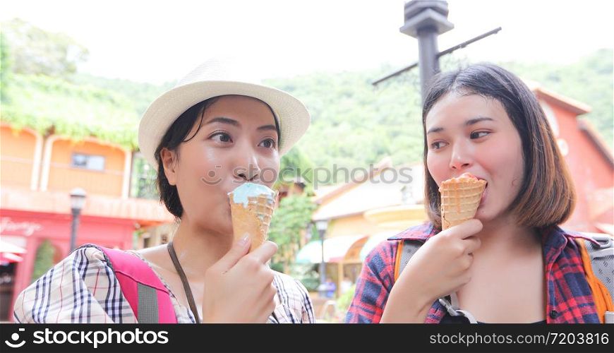 Beautiful female holding and eating ice cream on summer holidays