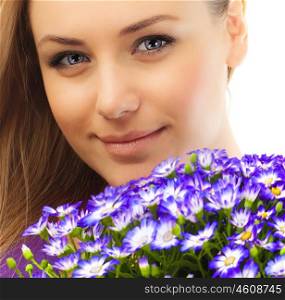 Beautiful female holding flowers, closeup on face, girl with bouquet of spring plant, bunch of purple cornflowers, lovely woman with gift isolated over white background