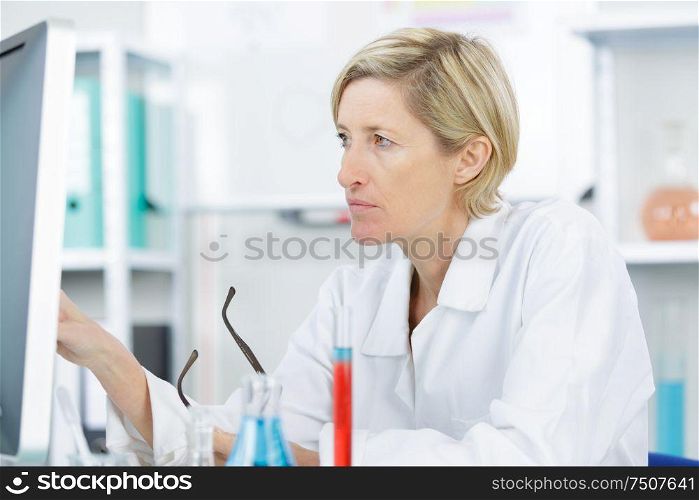 beautiful female lab worker analyzing tests