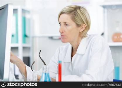 beautiful female lab worker analyzing tests
