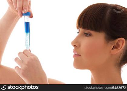 beautiful female lab worker holding up test tube