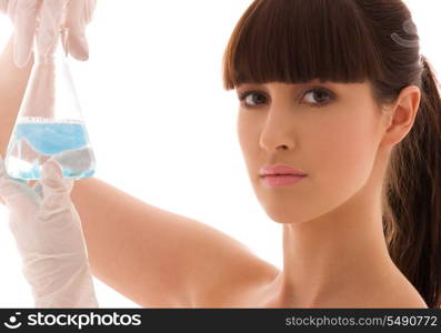 beautiful female lab worker holding up test tube