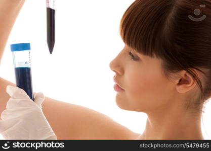 beautiful female lab worker holding up test tubes