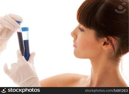 beautiful female lab worker holding up test tubes