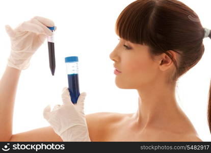 beautiful female lab worker holding up test tubes