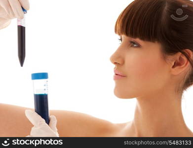 beautiful female lab worker holding up test tubes