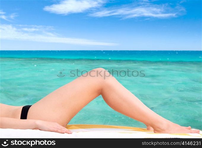 beautiful female legs against the sea background