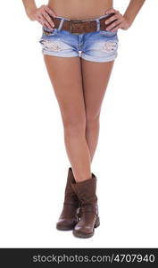 Beautiful female legs, part of the body. Blue short denim shorts and brown boots, isolated on white background