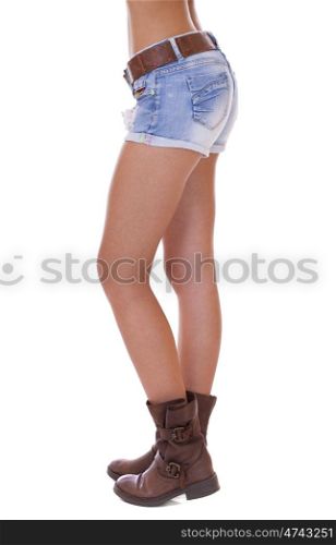 Beautiful female legs, part of the body. Blue short denim shorts and brown boots, isolated on white background