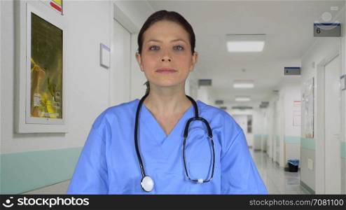 Beautiful female medical professional standing in a clinic