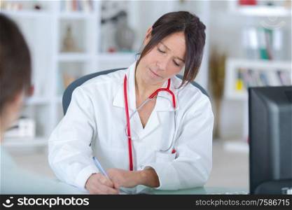beautiful female medicine doctor writing prescription
