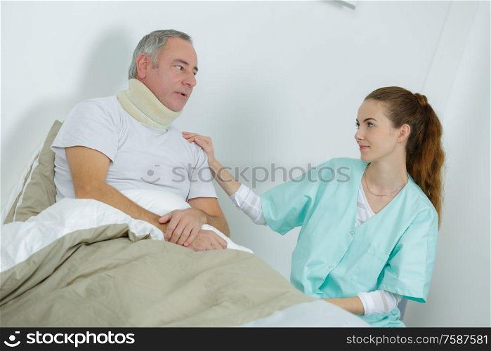 beautiful female nurse and an old man at the hospital