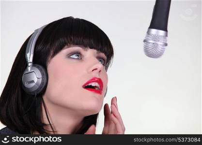 beautiful female singer singing in a studio