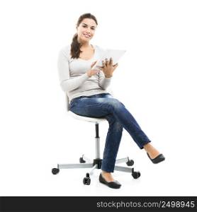 Beautiful female student sitting on a chair with a tablet, isolated over a white background