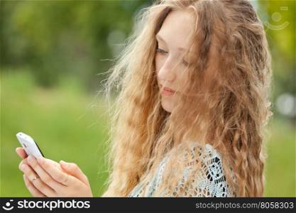 Beautiful Female Teenager Taking a Selfie with Phone Outdoors