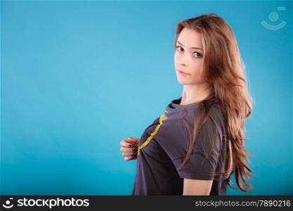 Beautiful female young woman teen girl with brown long healthy loose hair blue background