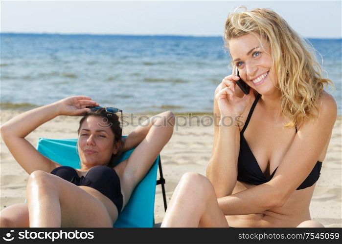 beautiful females enjoying vacation on beach