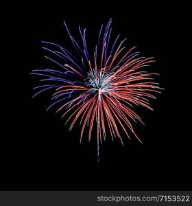 Beautiful festive blue and red fireworks display on night sky. New year and anniversary concept.