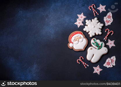 Beautiful festive Christmas gingerbread made by hand with decoration elements on a dark concrete background