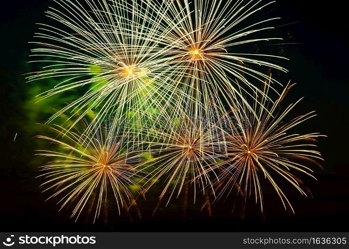 Beautiful festive fireworks in the night sky. Bright multi-colored salute on a black background. Place for text.. Festive fireworks in the night sky. Bright multi-colored salute on a black background. Place for text.