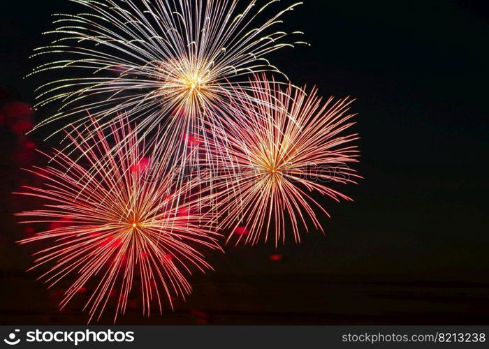 Beautiful festive fireworks in the sky for a holiday. Bright multi-colored salute on a black background. Place for text.. Festive fireworks in the sky for a holiday. Bright multi-colored salute on a black background. Place for text.