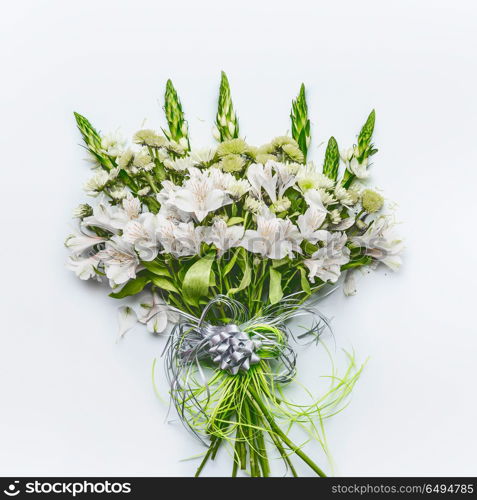 Beautiful festive flowers bouquet with bow and ribbon on white background