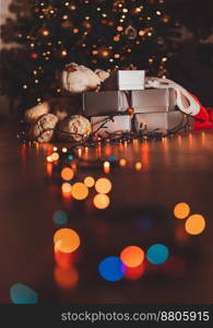 Beautiful Festive Home Interior. Christmas Eve Decoration. Bear near Gift Boxes Under Beautiful Xmas Tree with Colorful Lights.. Cozy Christmas Eve at Home