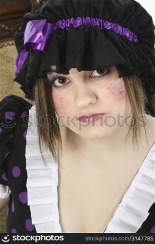 Beautiful fifteen year old teen girl dressed up in doll costume. Glitter freckles on cheeks.