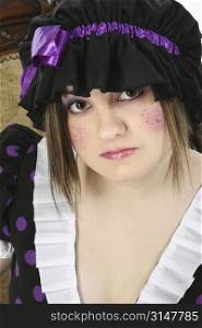 Beautiful fifteen year old teen girl dressed up in doll costume. Glitter freckles on cheeks.