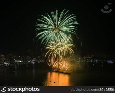 Beautiful firework on the sky at Pattaya coast with cityscape background, Thailand