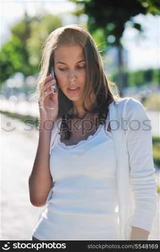beautiful fit young woman talk by cellphone in city at street on sunny day