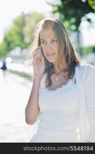 beautiful fit young woman talk by cellphone in city at street on sunny day