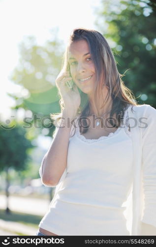 beautiful fit young woman talk by cellphone in city at street on sunny day