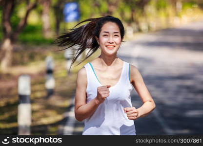 beautiful fitness woman running in the park