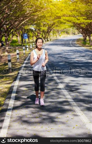 beautiful fitness woman running in the park