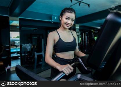 Beautiful fitness women prepare for running at the treadmill in the gym.
