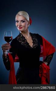 Beautiful flamenco dancer holding a glass of wine