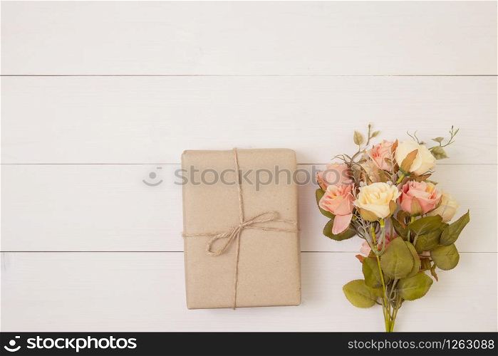 Beautiful flower and gift box on wooden background with romantic, presents for mother day or valentine day with pastel tone, spring or summer nature for decoration on desk, holiday concept.