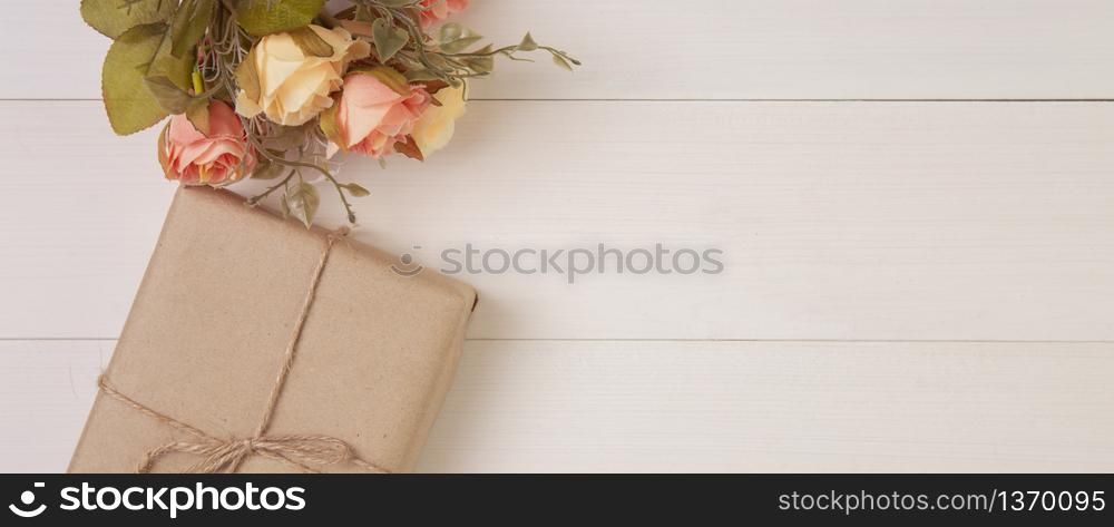 Beautiful flower and gift box on wooden background with romantic, presents for mother day or valentine day with pastel tone, decoration on desk, holiday concept, banner website.