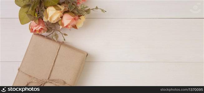 Beautiful flower and gift box on wooden background with romantic, presents for mother day or valentine day with pastel tone, decoration on desk, holiday concept, banner website.