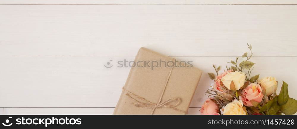 Beautiful flower and gift box on wooden background with romantic, presents for mother day or valentine day with pastel tone, nature for decoration on desk, holiday concept, banner website.